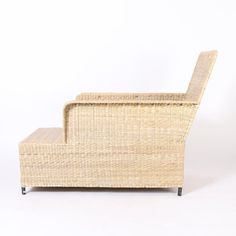 the back end of a wicker chair with its foot rest up on it's side