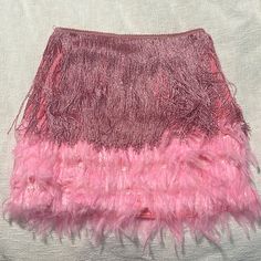 a pink and red skirt with feathers on it