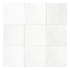 a white tile wall with squares in it