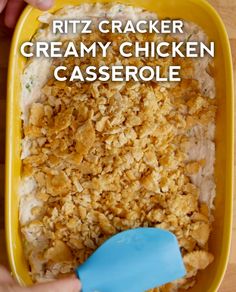 a person scooping some food out of a yellow casserole dish with the words ritz cracker creamy chicken casserole