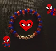 a spiderman bracelet with two beads and a heart shaped bead on the clasp