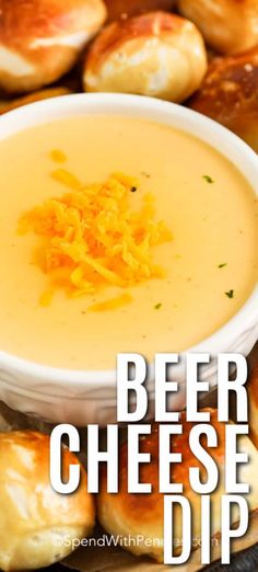 a bowl of beer cheese dip with bread rolls in the background and text overlay that reads, beer cheese dip