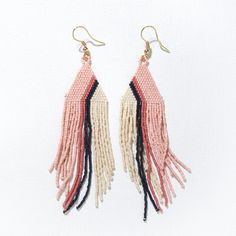 Our precision-cut glass Luxe beads in a daringly groovy colorway are just what your jewelry box is missing. Citron, mint, coral, navy + ivory beads are handwoven into a triangle shape with a modern diagonal stripe design that brings boho style to life in an approachable way. Flowy fringe takes these statement earrings to a whole new level with movement that turns heads with any outfit. Life is short - accessorize boldly. Citron, Mint, Coral + Navy Colors 4"L Made By Artisans In India Glass + Bra Adjustable Triangle Beaded Earrings, Handwoven Pink Jewelry For Summer, Summer Handwoven Pink Jewelry, Bohemian Triangle Beaded Earrings, Bohemian Triangle Jewelry With Dangling Beads, Adjustable Geometric Beaded Jewelry, Adjustable Triangle Beaded Jewelry, Adjustable Triangular Beaded Jewelry, Pink Terracotta