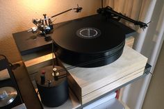 a record player sitting on top of a stack of records