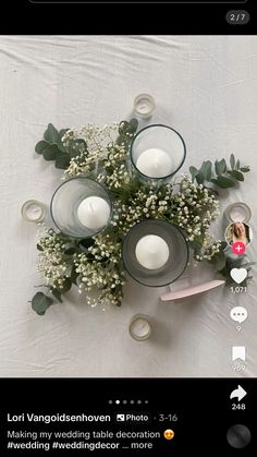 flowers and candles are arranged on a white table cloth with the text, i love you