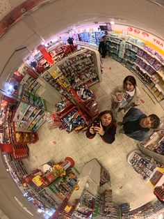 two people standing in front of a store looking at the camera