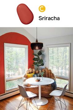 an image of a dining room with red walls and white furniture in the center, there is a round table surrounded by four chairs