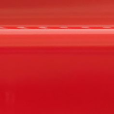 a close up view of the side of a red car