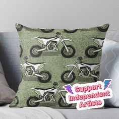 a green and white throw pillow with an image of a dirt bike on the front