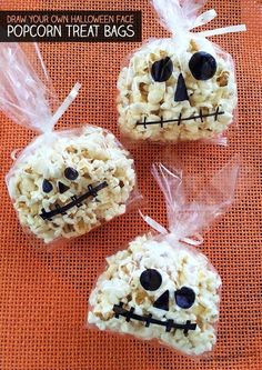 three halloween popcorn treat bags with faces on them