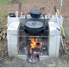 an outdoor bbq is set on fire with pots and pans cooking over it