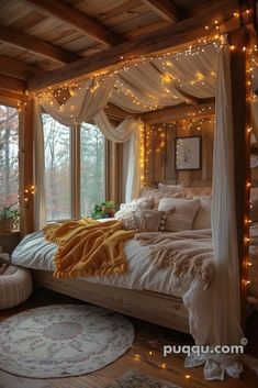 a bed with white sheets and lights on the headboard is in front of a window