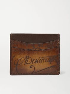 In this digital age, artisan craftsmanship is all the more special, something that Berluti knows well. This cardholder is made from the brand's famous Venezia leather which is hand-treated for a rich patina and shine, and inscribed with cursive lettering that references an 18th century manuscript found at auction. Its slim profile is fitted with four slots and a central compartment. Designer Leather Card Holder With Engraved Logo, Designer Brown Card Holder, Designer Brown Bifold Card Holder, Designer Brown Card Holder As Gift, Designer Brown Card Holder For Gift, Designer Brown Card Holder For Everyday, Designer Leather Card Holder With Card Slots, Vintage Brown Card Holder With Rfid Blocking, Designer Brown Card Holder For Formal Occasions