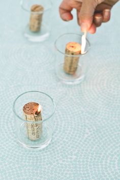 three wine corks in small glass holders on a table