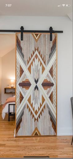 a wooden door with an abstract design on the front and back side, in a living room