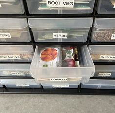 plastic bins with food items in them and labeled labels reading root veg herbs