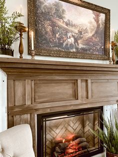 a fireplace with a painting on the wall above it