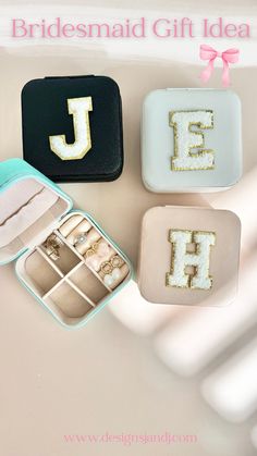 three small boxes with wedding rings in them and the letters j, j, h