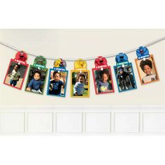 a birthday banner with pictures of children hanging from it