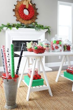 a table with christmas decorations on it in front of a fireplace