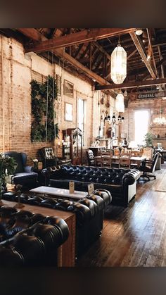 a living room filled with black leather couches