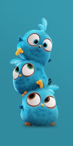 three blue birds with big eyes are standing next to each other