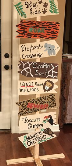 a wooden sign with many different types of signs on it in front of a door