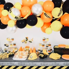 a table topped with lots of desserts and balloons