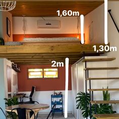 the loft bed is built into the wall above the table and below it are two stairs that lead up to the second floor