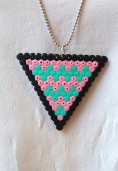 a pink and black triangle necklace on a chain