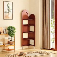 a living room filled with furniture and a wooden book shelf next to a window on top of a hard wood floor