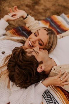 a man and woman laying on top of each other