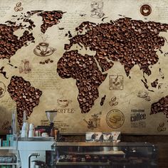 a coffee shop with a world map on the wall and lots of coffee beans all over it