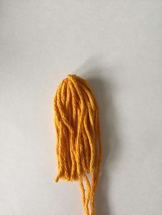 the yellow yarn is being used to make hair