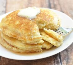 a stack of pancakes with butter on top