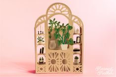 a wooden shelf with plants and vases on it against a pink background that says happy mother's day