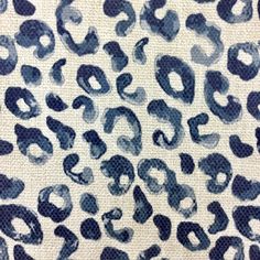 an animal print fabric with blue and black spots on it's surface, showing the pattern