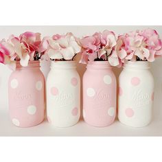 three pink and white polka dot mason jars with flowers in them