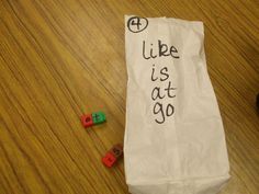 a paper bag with words written on it sitting next to some legos and a computer mouse