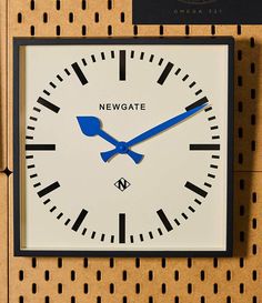 a clock on the wall that says newgate in black and white letters with blue hands