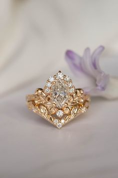 a close up of a ring on a white surface with flowers in the foreground