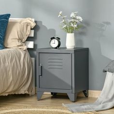 a small gray locker next to a bed