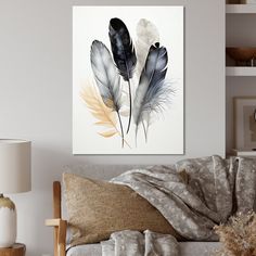 a living room scene with focus on the couch and two feathers hanging on the wall