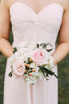 a bride holding a bouquet of flowers in her hands