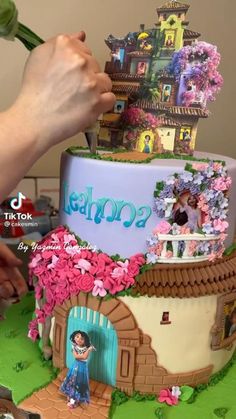 someone is decorating a cake with the theme of dora's palace on it