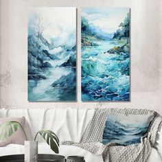 two paintings are hanging on the wall above a couch in a room with white furniture