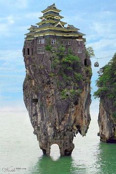 an island in the middle of the ocean with a castle on it's head