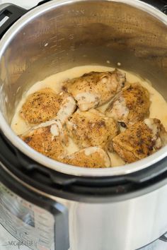 the chicken is being cooked in the crock pot