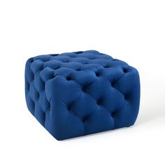 a blue square footstool sitting on top of a white floor