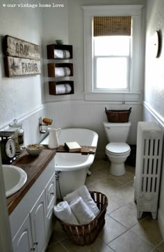 a bathroom with a toilet, sink and bathtub in the corner next to a radiator